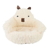 Dog resting comfortably on a soft sofa dog bed in a cozy living room