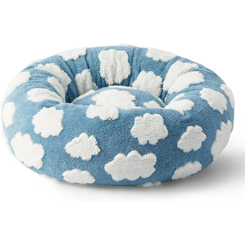 Puppy sleeping peacefully in a warm donut dog bed